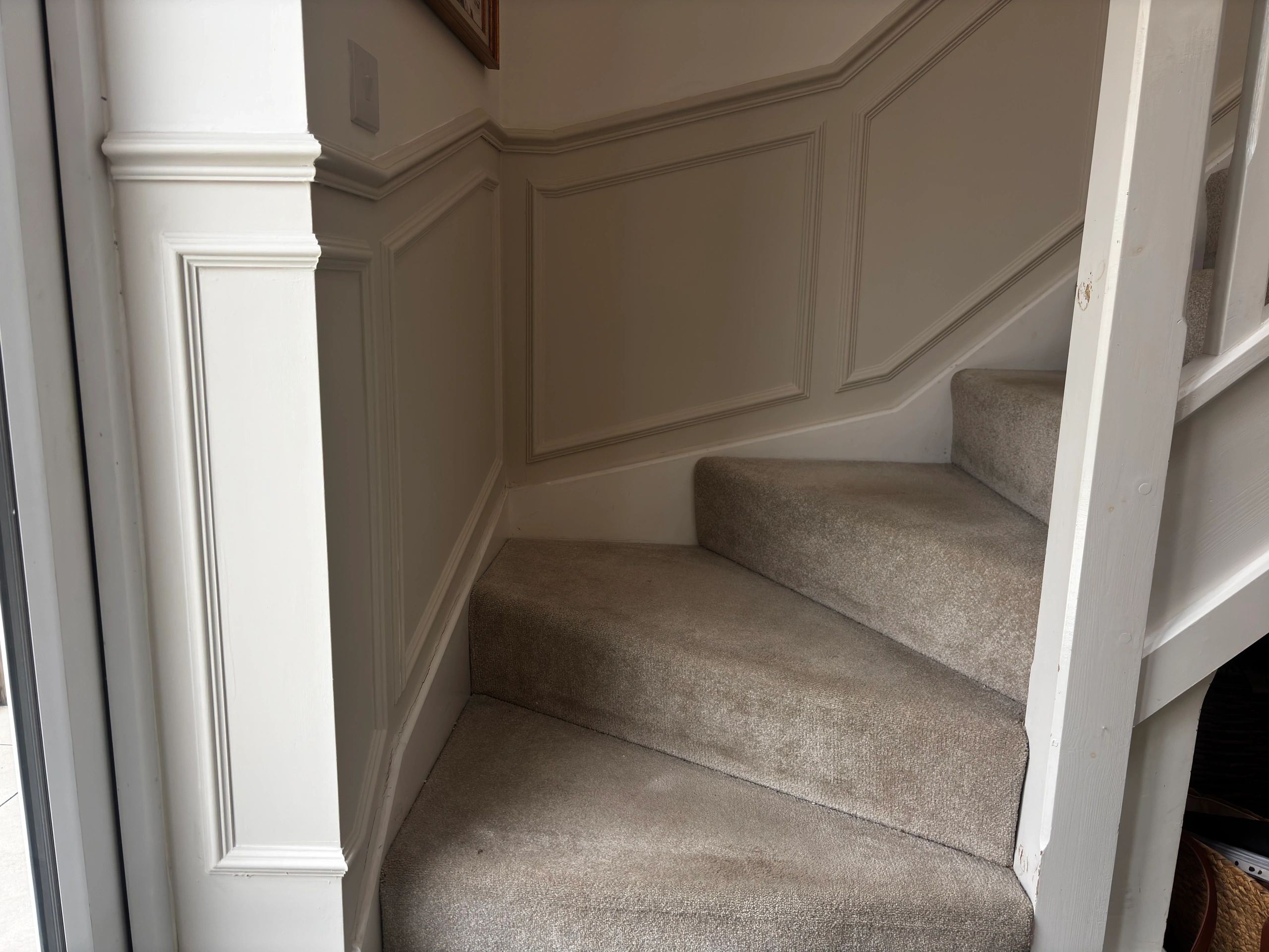 Staircase with white panelling